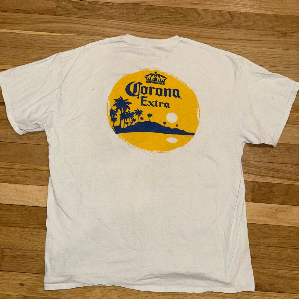 Corona Extra White T-Shirt with Yellow and Blue Graphic.